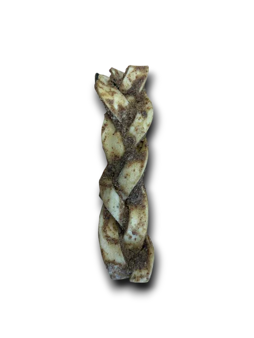 Twisted rawhide dog chew twisted with seasoning on black background