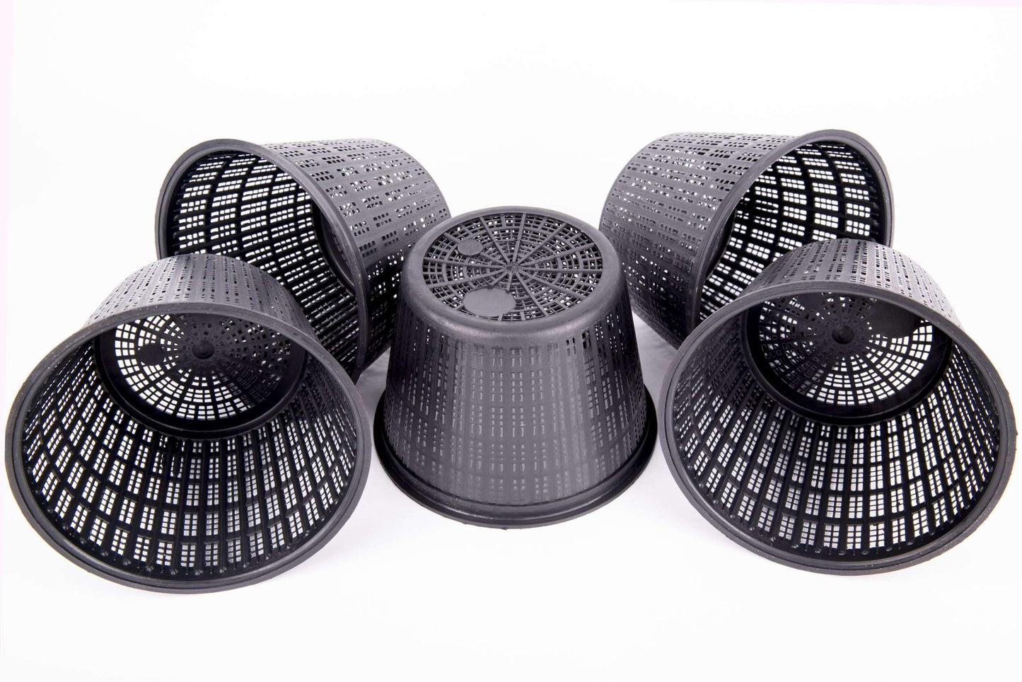 Set of five black plastic mesh plant pots with drainage holes on white background