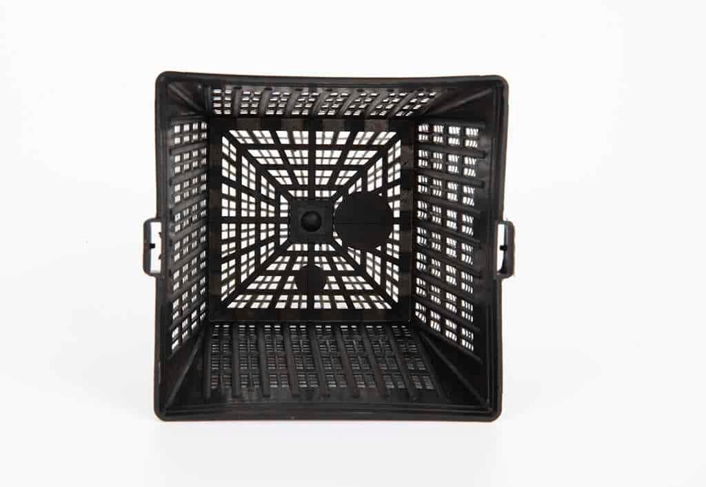 Top view of an empty black plastic mesh storage crate with handles on a white background